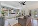 Bright living room with built-in shelving, a comfortable grey sofa, and access to the outdoor patio with a pool at 3226 Helen Ave, Orlando, FL 32804