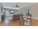 Spacious living room with built-in shelving, a dark grey sofa, and a small breakfast nook next to the kitchen at 3226 Helen Ave, Orlando, FL 32804