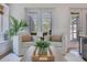 Bright living room features white sofas, a modern coffee table, and patio views through the French doors at 3226 Helen Ave, Orlando, FL 32804