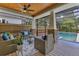 Screened-in patio with wicker furniture, ceiling fan and brick-based support columns at 3226 Helen Ave, Orlando, FL 32804