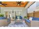 Outdoor screened-in patio featuring two loveseats, two chairs, and a ceiling fan at 3226 Helen Ave, Orlando, FL 32804