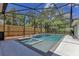 A screened-in pool features a built-in spa, tile accents, and a paved patio, creating a relaxing outdoor oasis at 3226 Helen Ave, Orlando, FL 32804