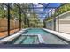 Screened-in swimming pool featuring an attached hot tub and a small waterfall feature at 3226 Helen Ave, Orlando, FL 32804