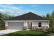 Charming single-story home features stone accents, a two-car garage, and a well-manicured lawn at 3821 Elk Bluff Rd, St Cloud, FL 34772
