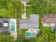 An aerial view displays a home with a backyard pool and mature trees in a residential neighborhood at 404 Broadview Ave, Altamonte Springs, FL 32701