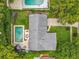 An aerial view of a well-maintained home with a pool, manicured lawn, and surrounding trees at 404 Broadview Ave, Altamonte Springs, FL 32701