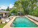 A private backyard featuring a sparkling pool, a gazebo, and mature trees, creating a tranquil outdoor living space at 404 Broadview Ave, Altamonte Springs, FL 32701