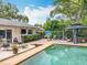 Inviting backyard with a pool, gazebo, lounge chairs, and lush landscaping, creating a serene retreat at 404 Broadview Ave, Altamonte Springs, FL 32701