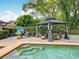 Backyard oasis featuring a covered gazebo, outdoor seating, and a refreshing pool at 404 Broadview Ave, Altamonte Springs, FL 32701