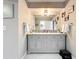 Bathroom featuring a dual sink vanity with gray cabinetry, a large mirror, and neutral wall color at 404 Broadview Ave, Altamonte Springs, FL 32701