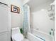 Clean bathroom featuring a white toilet, bathtub with shower, and playful decor elements at 404 Broadview Ave, Altamonte Springs, FL 32701