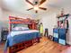 Cozy bedroom featuring a bunk bed with red accents, hardwood floors, and playful decor at 404 Broadview Ave, Altamonte Springs, FL 32701