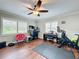 This bedroom features hardwood floors, a ceiling fan, and a dedicated computer workstation at 404 Broadview Ave, Altamonte Springs, FL 32701