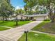 Beautiful home with a well-maintained lawn, mature trees, and an expansive driveway leading to the garage at 404 Broadview Ave, Altamonte Springs, FL 32701