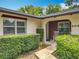 Inviting front porch featuring a cozy seating area with rocking chairs and manicured landscaping at 404 Broadview Ave, Altamonte Springs, FL 32701