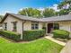 Charming single-story home featuring a well-manicured lawn and beautiful landscaping with mature trees at 404 Broadview Ave, Altamonte Springs, FL 32701