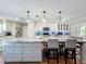 Kitchen island with seating, granite countertop, pendant lighting, and stainless steel appliances at 404 Broadview Ave, Altamonte Springs, FL 32701