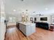 Open concept living area with kitchen island, hardwood floors, and comfortable seating at 404 Broadview Ave, Altamonte Springs, FL 32701