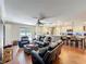 Open living room flows into kitchen with island, hardwood flooring, and leather furniture at 404 Broadview Ave, Altamonte Springs, FL 32701