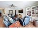 Spacious living room with hardwood floors, leather seating, and custom built-in shelving at 404 Broadview Ave, Altamonte Springs, FL 32701