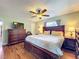 This main bedroom features hardwood floors, a ceiling fan, and a complete dark wood bedroom set at 404 Broadview Ave, Altamonte Springs, FL 32701