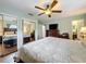 This main bedroom features hardwood floors, a ceiling fan, and a complete dark wood bedroom set at 404 Broadview Ave, Altamonte Springs, FL 32701