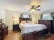 This main bedroom features hardwood floors, a ceiling fan, and a complete dark wood bedroom set at 404 Broadview Ave, Altamonte Springs, FL 32701