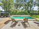 Backyard pool area with lounge chairs, lush landscaping, and a covered gazebo for outdoor relaxation at 404 Broadview Ave, Altamonte Springs, FL 32701