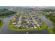 An aerial view of a lakeside neighborhood featuring well-maintained homes and lush landscaping at 4952 Longmeadow Park St, Orlando, FL 32811