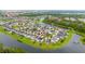 Panoramic aerial view of a lovely community surrounded by mature trees and a large lake at 4952 Longmeadow Park St, Orlando, FL 32811