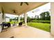 Inviting covered back porch with seating area and ceiling fans overlooking the tranquil water view at 4952 Longmeadow Park St, Orlando, FL 32811