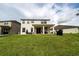 Expansive backyard with lush green grass, patio area, and views of neighboring homes at 4952 Longmeadow Park St, Orlando, FL 32811