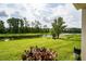 Lush green backyard with a serene pond and mature trees, offering privacy at 4952 Longmeadow Park St, Orlando, FL 32811