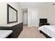 Bedroom featuring a dresser with mirror, television, and a doorway leading to additional rooms at 4952 Longmeadow Park St, Orlando, FL 32811