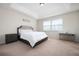 Cozy bedroom features a comfortable bed, side table, and a well-lit workspace near the window at 4952 Longmeadow Park St, Orlando, FL 32811