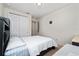 Bright bedroom featuring neutral walls, carpet, and a closet; furnished with a bed and small desk at 4952 Longmeadow Park St, Orlando, FL 32811