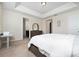 Well-lit bedroom with comfortable bed, dresser, and a view into the en-suite bathroom at 4952 Longmeadow Park St, Orlando, FL 32811