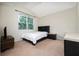 Bright bedroom with large window, cozy bed, side table, and media center at 4952 Longmeadow Park St, Orlando, FL 32811
