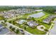 Aerial view showcases community clubhouse and pool near the lake at 4952 Longmeadow Park St, Orlando, FL 32811
