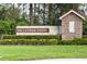 An artistic stone sign for Millenia Park near lush green bushes and thick green grass at 4952 Longmeadow Park St, Orlando, FL 32811