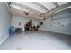A spacious garage with speckled epoxy flooring and storage solutions along the back wall at 4952 Longmeadow Park St, Orlando, FL 32811