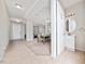 Open hallway leading to various rooms, featuring tile flooring and natural light at 4952 Longmeadow Park St, Orlando, FL 32811