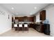 Modern kitchen with stainless steel appliances, dark cabinetry, and a breakfast bar at 4952 Longmeadow Park St, Orlando, FL 32811