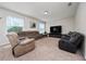 Spacious living room with comfortable seating, a large TV, and natural light from the windows at 4952 Longmeadow Park St, Orlando, FL 32811