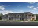 Charming townhomes featuring attached garages and manicured front lawns under a bright blue sky at 504 Pine Ridge Ct, Lake Wales, FL 33859