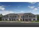 Modern townhome exterior with individual garages, craftsman details, and welcoming curb appeal at 512 Pine Ridge Ct, Lake Wales, FL 33859