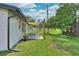 Cozy backyard patio with seating and a shade sail offering relaxing views of the neighborhood at 550 Eagle Dr, Daytona Beach, FL 32117