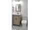 Updated bathroom featuring a wood-toned vanity, white marble floors, and a modern toilet at 550 Eagle Dr, Daytona Beach, FL 32117