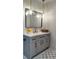 Bathroom vanity with a modern design, gray cabinetry, quartz countertop, and pendant lights at 550 Eagle Dr, Daytona Beach, FL 32117