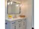 Bright bathroom vanity with gold hardware, gray cabinets, quartz counters, and lovely glass pendant lighting at 550 Eagle Dr, Daytona Beach, FL 32117